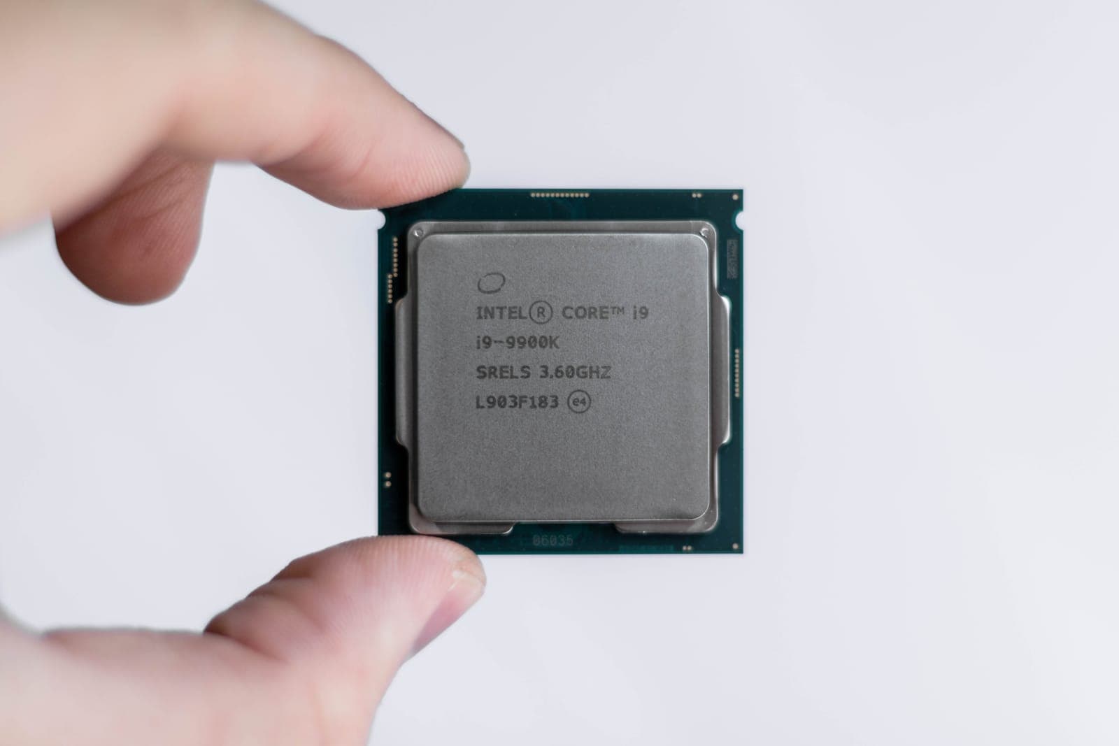 Fingers holding a computer processor chip