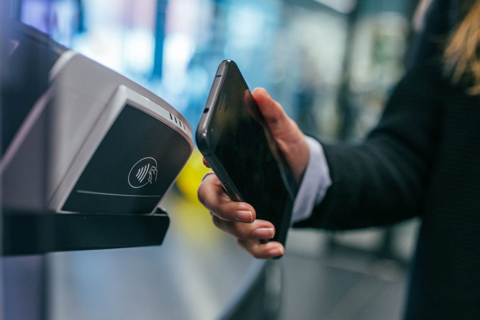 A smartphone held to a card terminal to pay